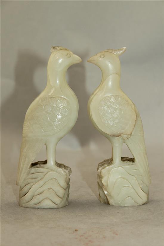 A pair of celadon-white jade standing figures of pheasants, 20th century, 4.3cm, chips to crests